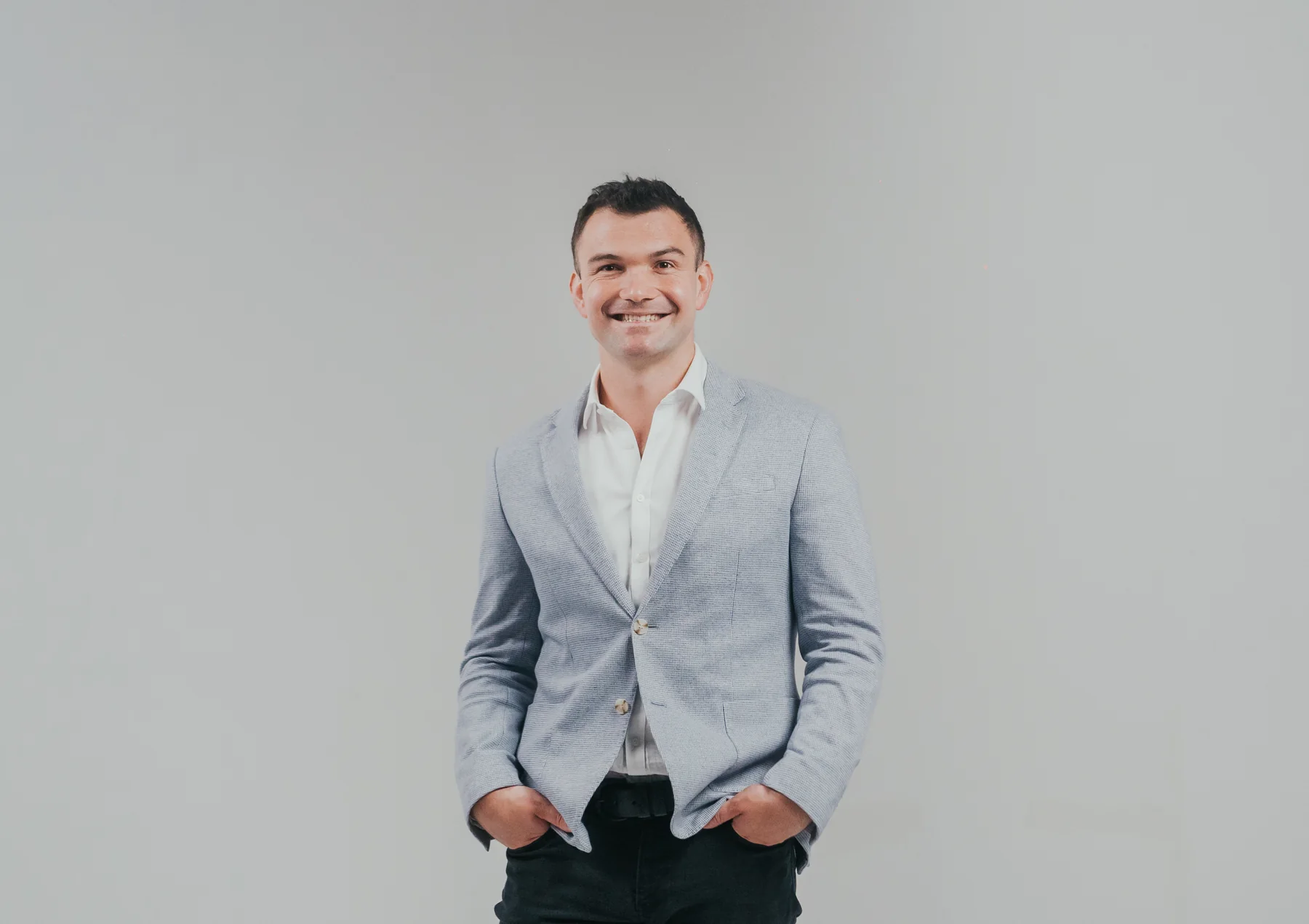 Matthew Horncastle in a light jacket against a neutral studio background