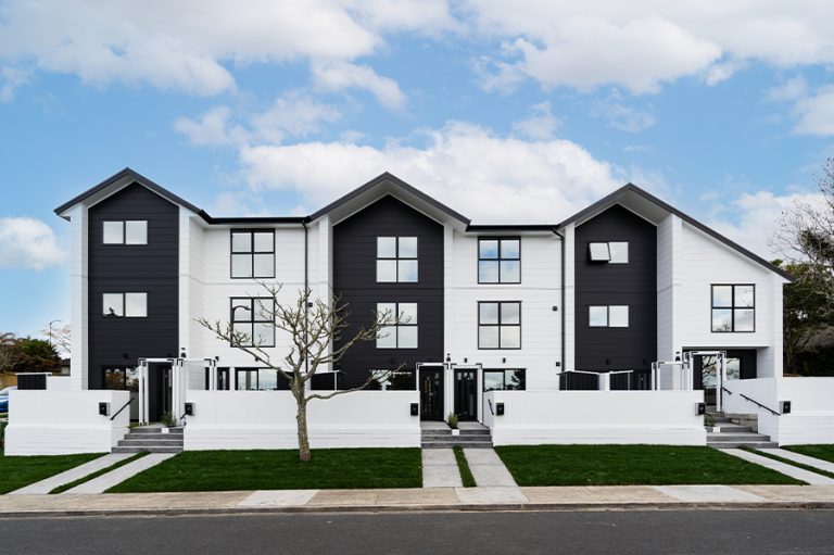 Completed black-and-white townhouses with front gardens at 2 Jadewynn Drive, Massey